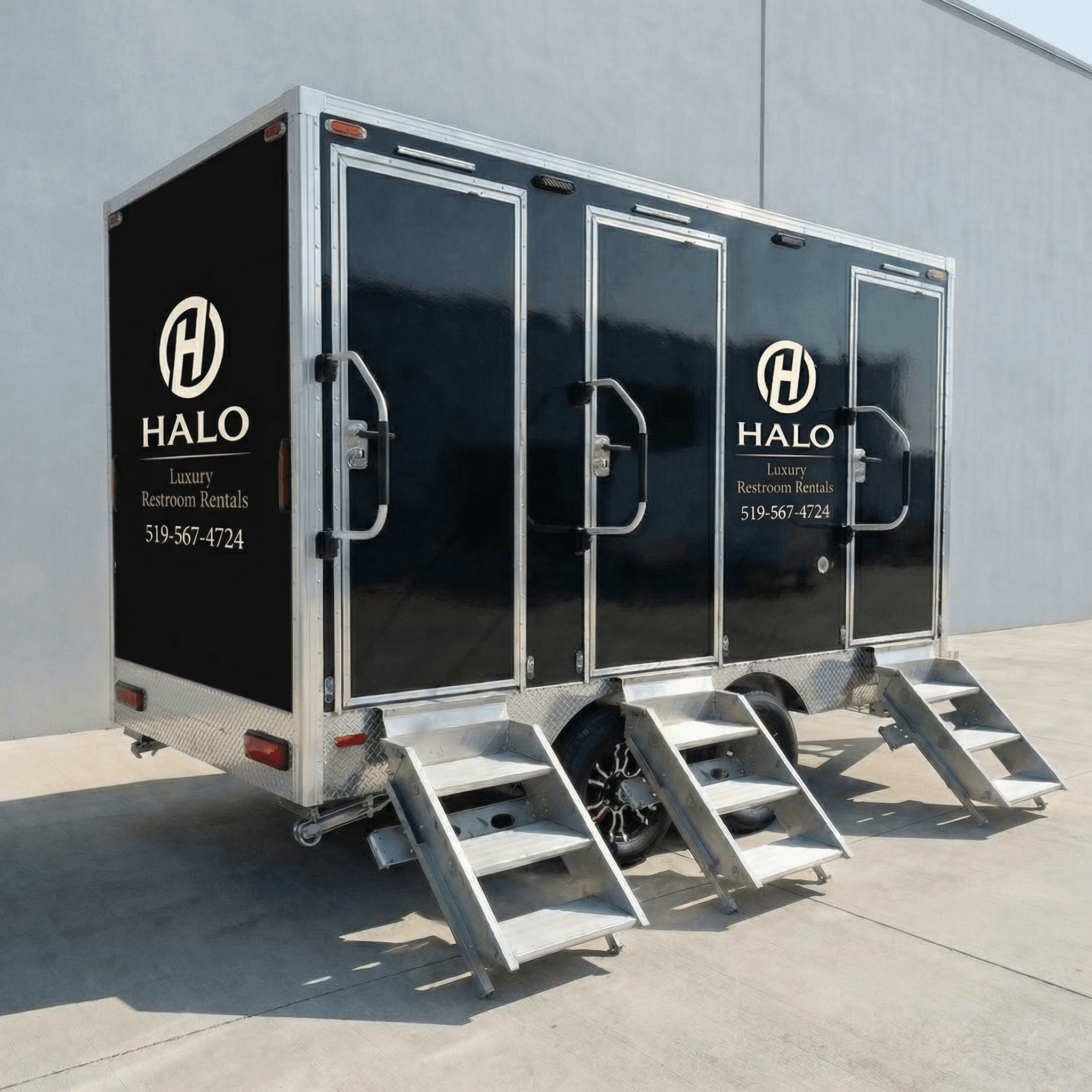 Black luxury mobile restroom trailer with three doors, silver stairs, and Halo branding on the side.